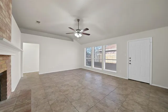 a view of an empty room with a fireplace