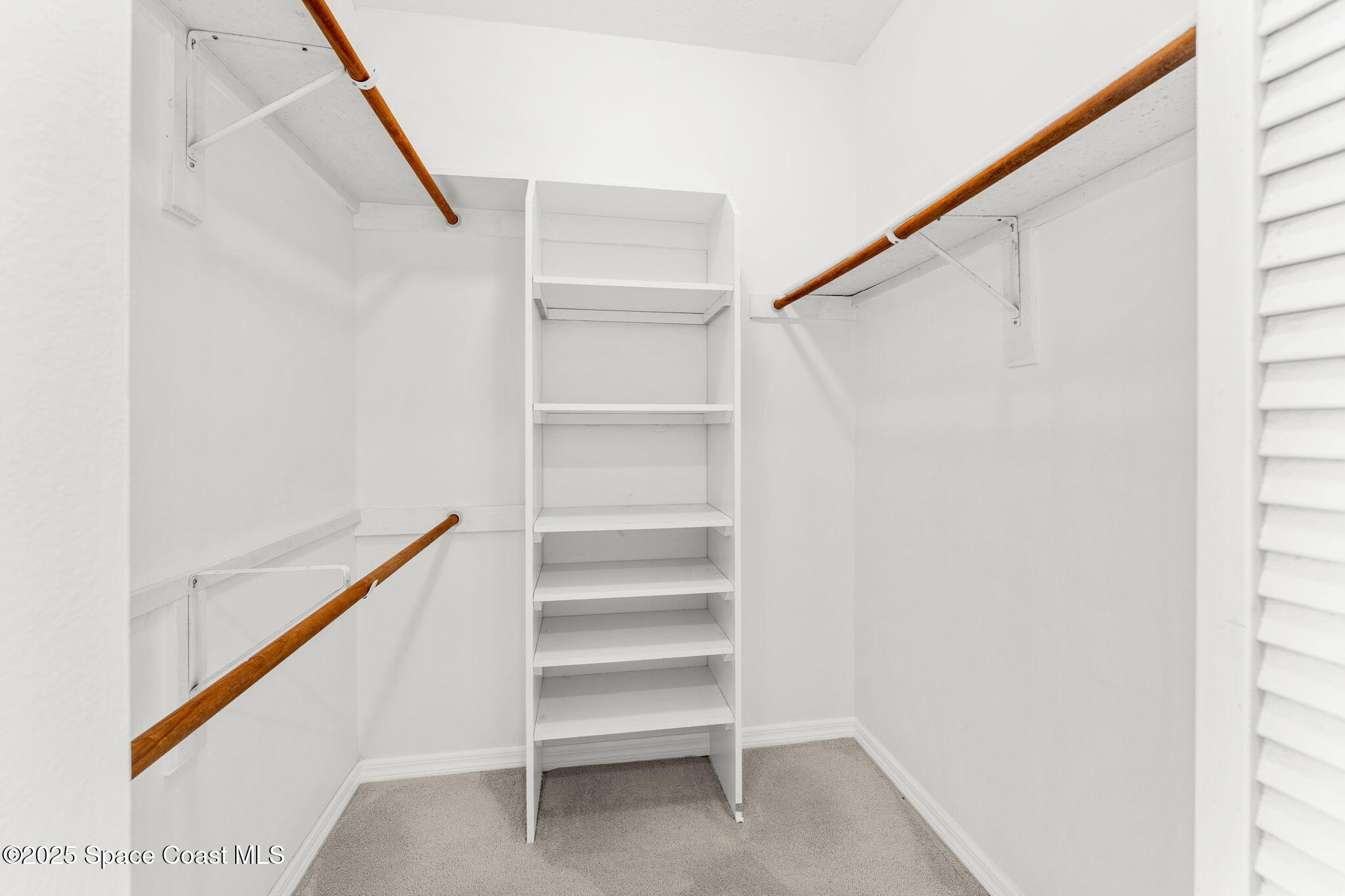 102 Riverside Drive, Unit 605 Cocoa, FL 32922 - Photo 34 of 84 Primary Walk-in Closet Views