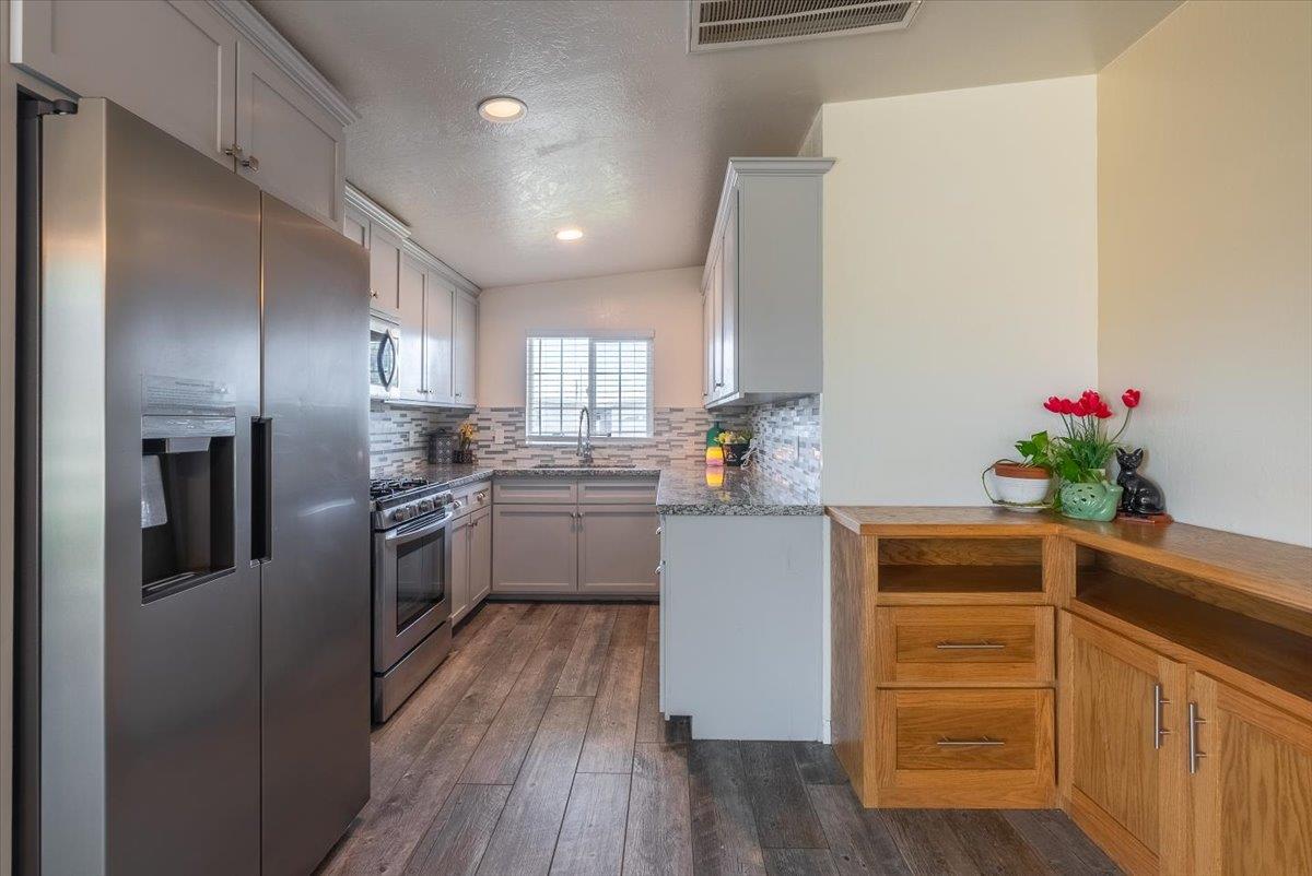 701 Cornell Avenue Salinas, CA 93901 - Photo 11 of 40 a kitchen with granite countertop stainless steel appliances and wooden floor
