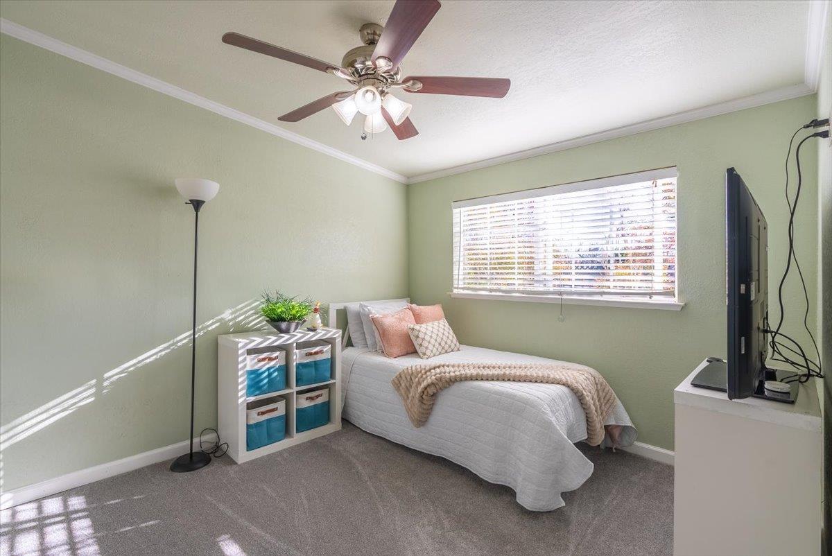 701 Cornell Avenue Salinas, CA 93901 - Photo 15 of 40 a bedroom with a bed and a chandelier