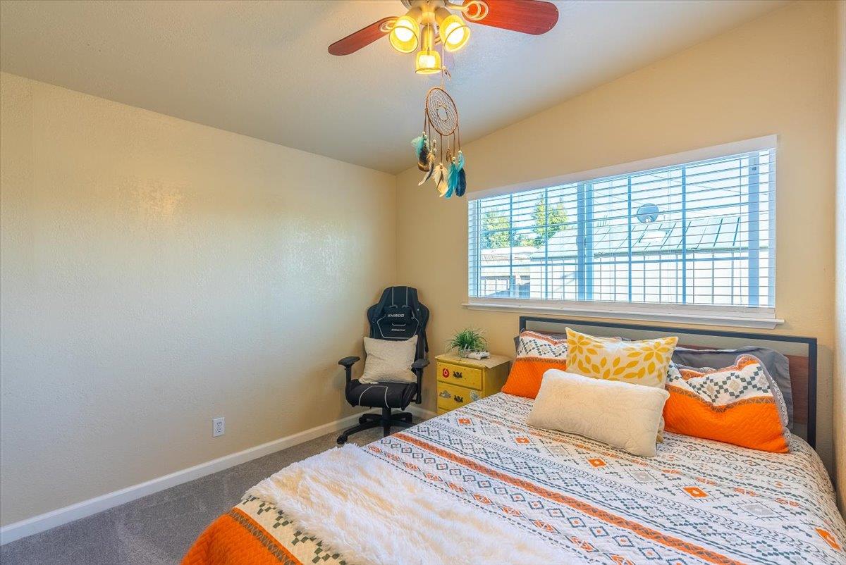 701 Cornell Avenue Salinas, CA 93901 - Photo 20 of 40 a bedroom with a bed and a chandelier