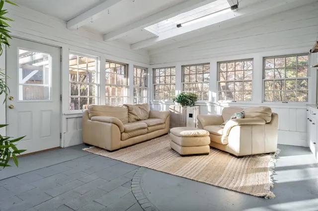 a living room with furniture and large windows