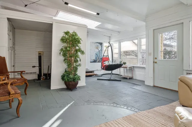 a bedroom with furniture and a window