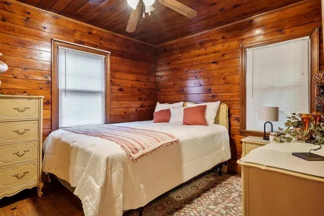 a bedroom with a bed and wooden floor