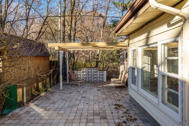 a wooden bench sitting in front of a building