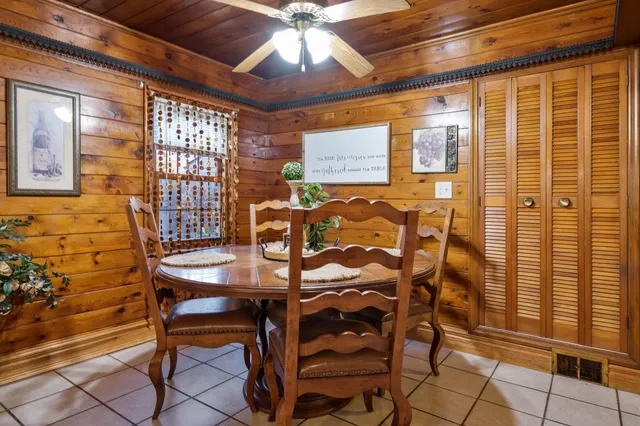 a view of a dining room with furniture and a chandelier