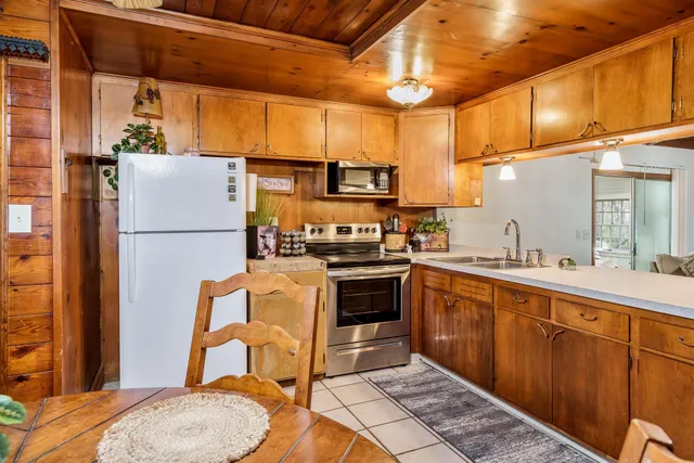 a kitchen with stainless steel appliances granite countertop a refrigerator and a stove top oven