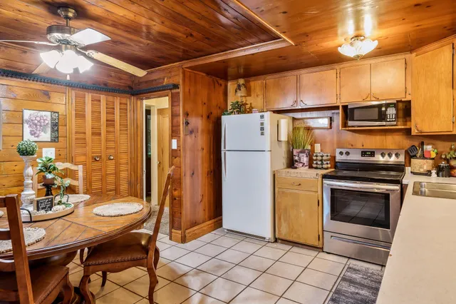 a kitchen with furniture a refrigerator and a stove