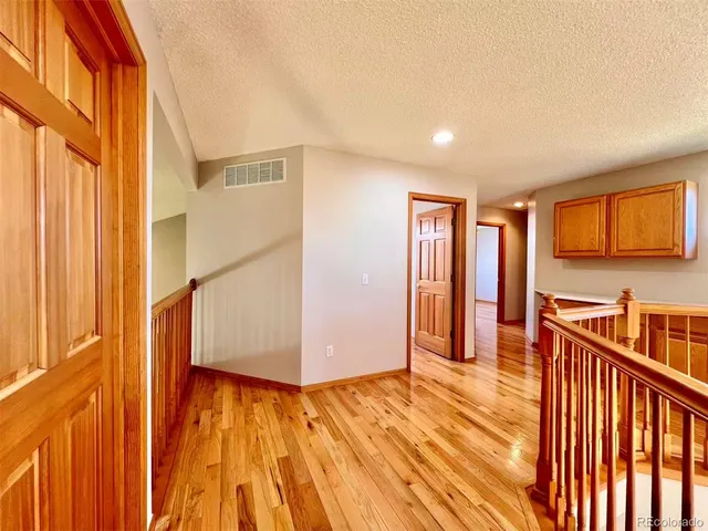 a view of a room with wooden floor and stairs