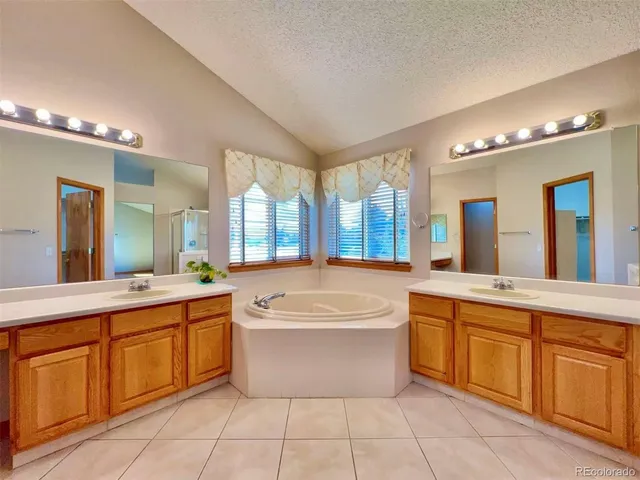 a large bathroom with a large tub and sink