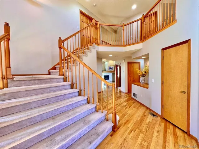 a view of entryway and hall with wooden floor
