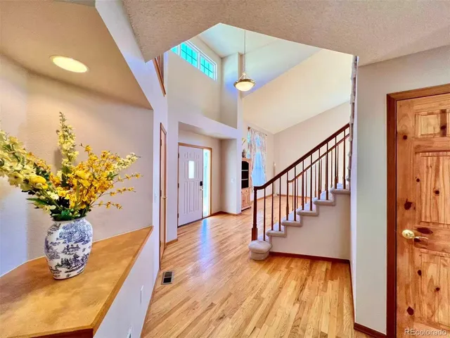 a view of entryway and hall with wooden floor
