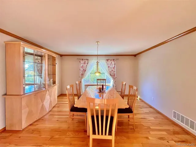 a view of a dining room with furniture window and wooden floor
