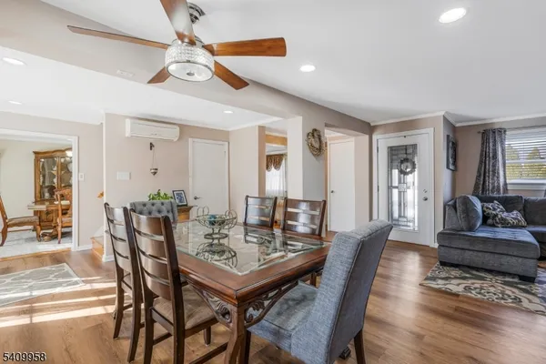 a view of a a dining room with furniture window and wooden floor