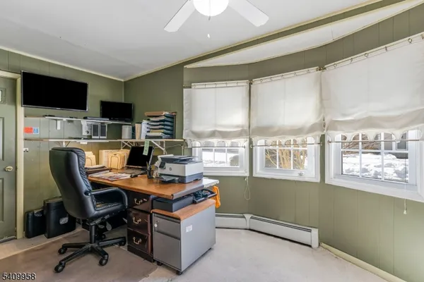 a workspace with furniture and a flat screen tv