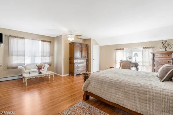 a bedroom with a bed and large window