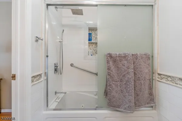 a bathroom with a bathtub and shower
