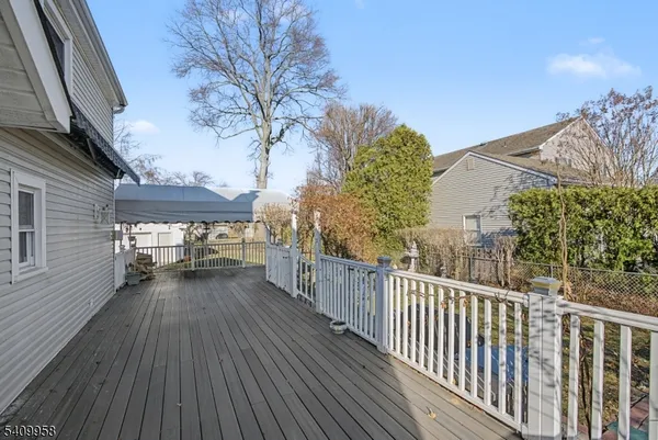 a view of a porch with wooden floor and fence