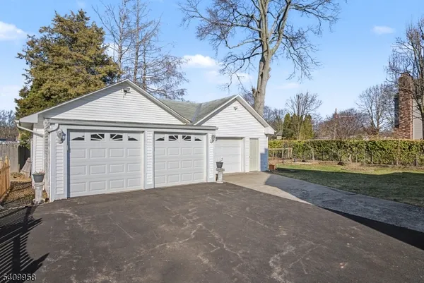 a view of a house with a yard and garage
