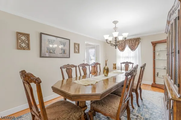 a view of a dining room with furniture and chandelier