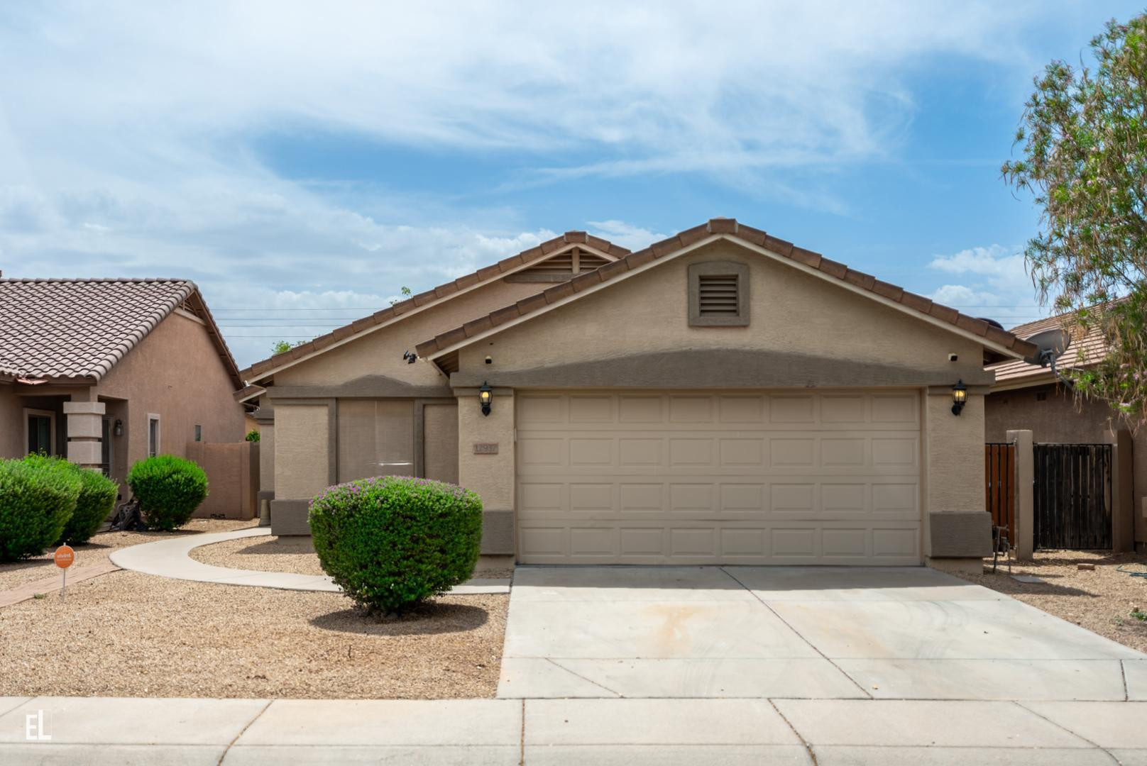 a front view of a house with garage