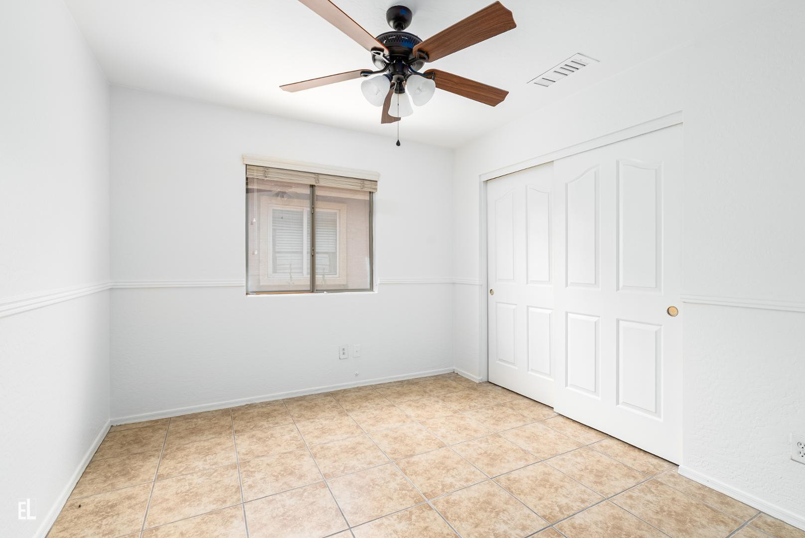 12937 West Bloomfield Road El Mirage, AZ 85335 - Photo 13 of 25 an empty room with windows and fan