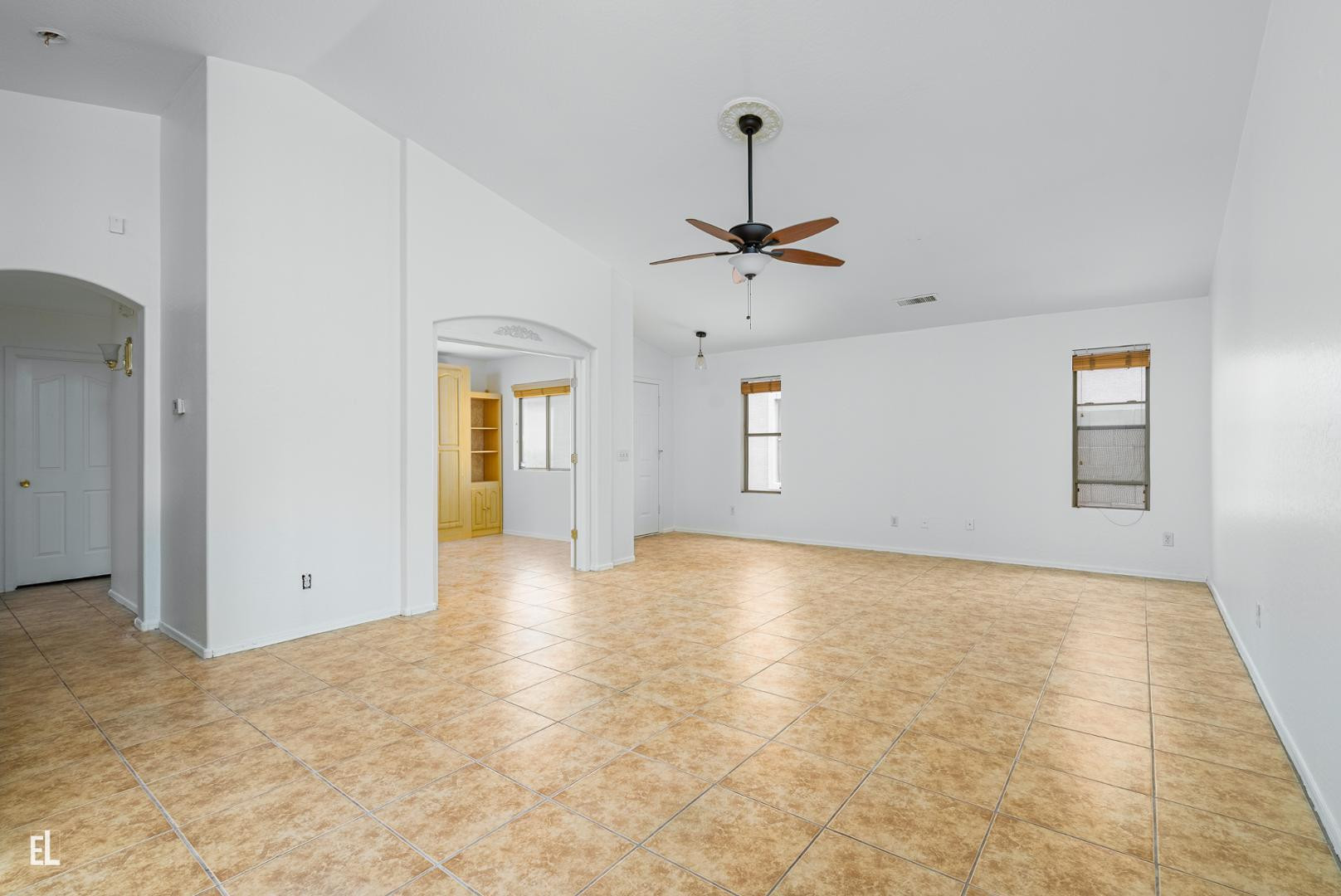 12937 West Bloomfield Road El Mirage, AZ 85335 - Photo 7 of 25 a view of an empty room with window and chandelier fan