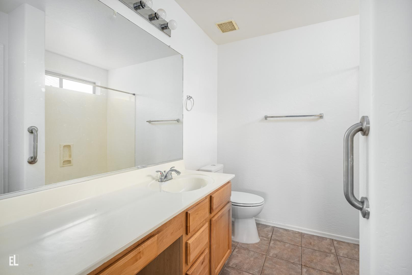 12937 West Bloomfield Road El Mirage, AZ 85335 - Photo 9 of 25 a bathroom with a sink a toilet and shower