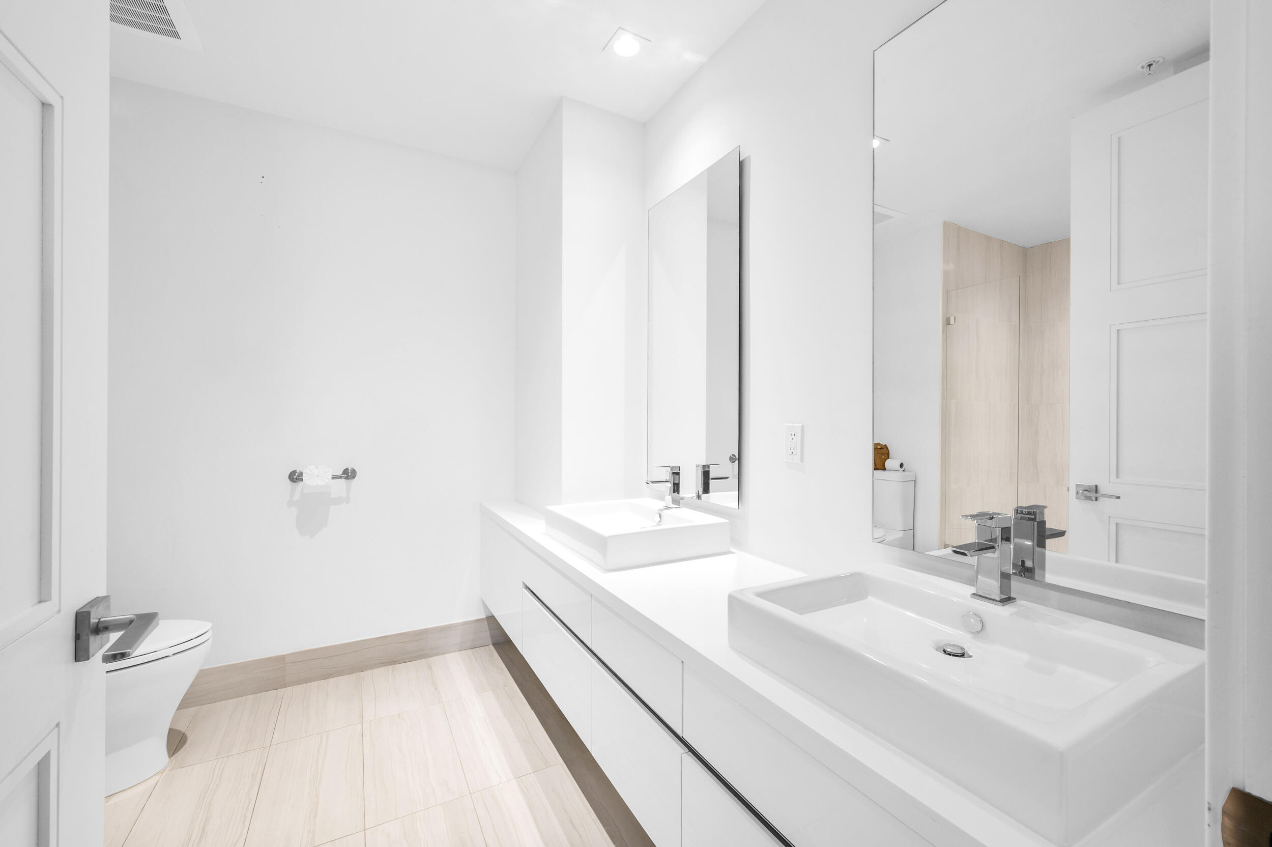 155 East Boca Raton Road, Unit 418 Boca Raton, FL 33432 - Photo 13 of 51 a bathroom with a sink a toilet and a large mirror