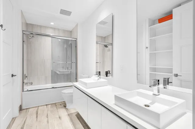 a bathroom with double vanity sink and a mirror