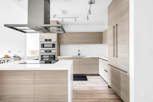a kitchen with stainless steel appliances kitchen island granite countertop a sink and stove