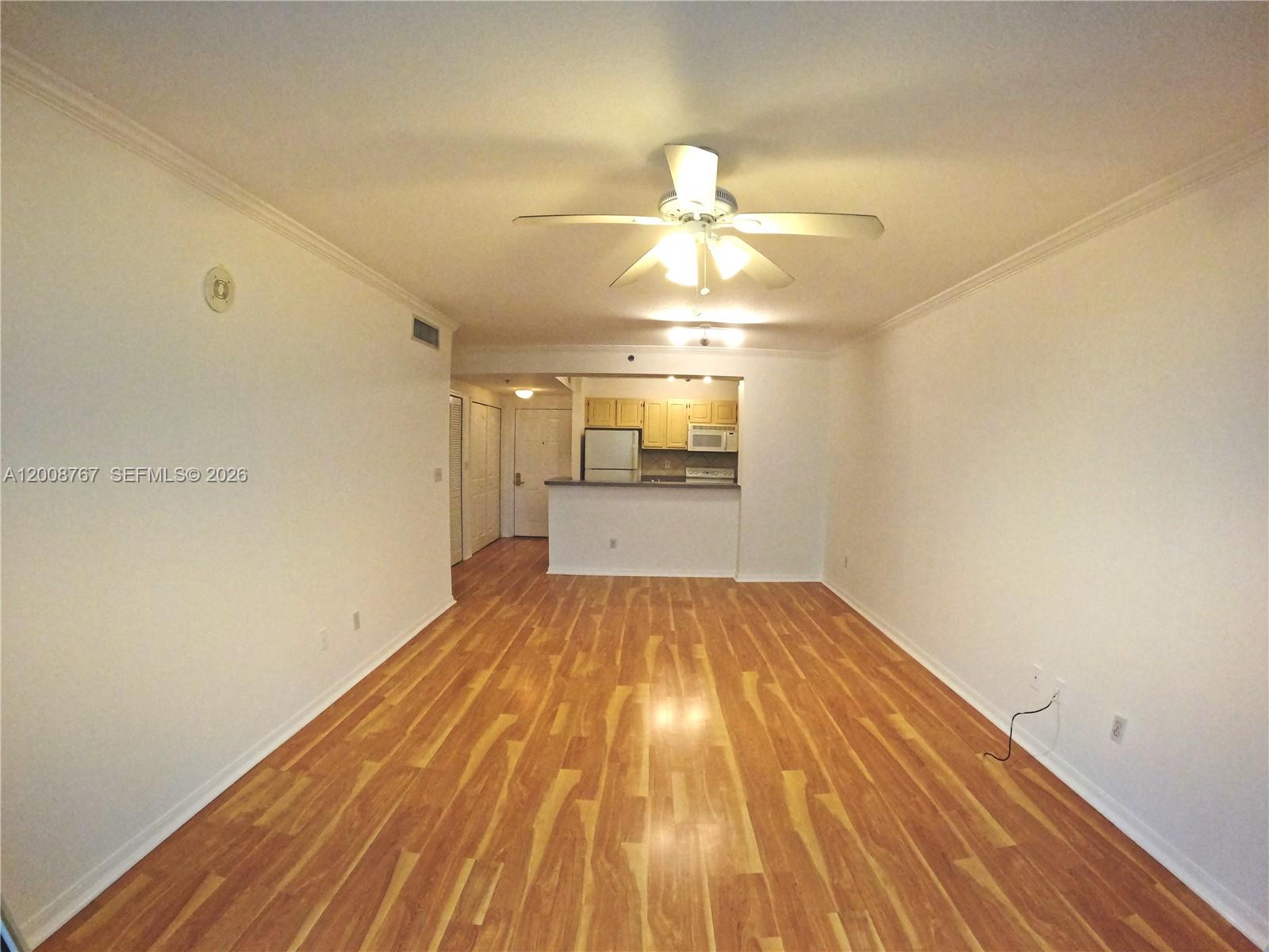 a view of empty room with wooden floor
