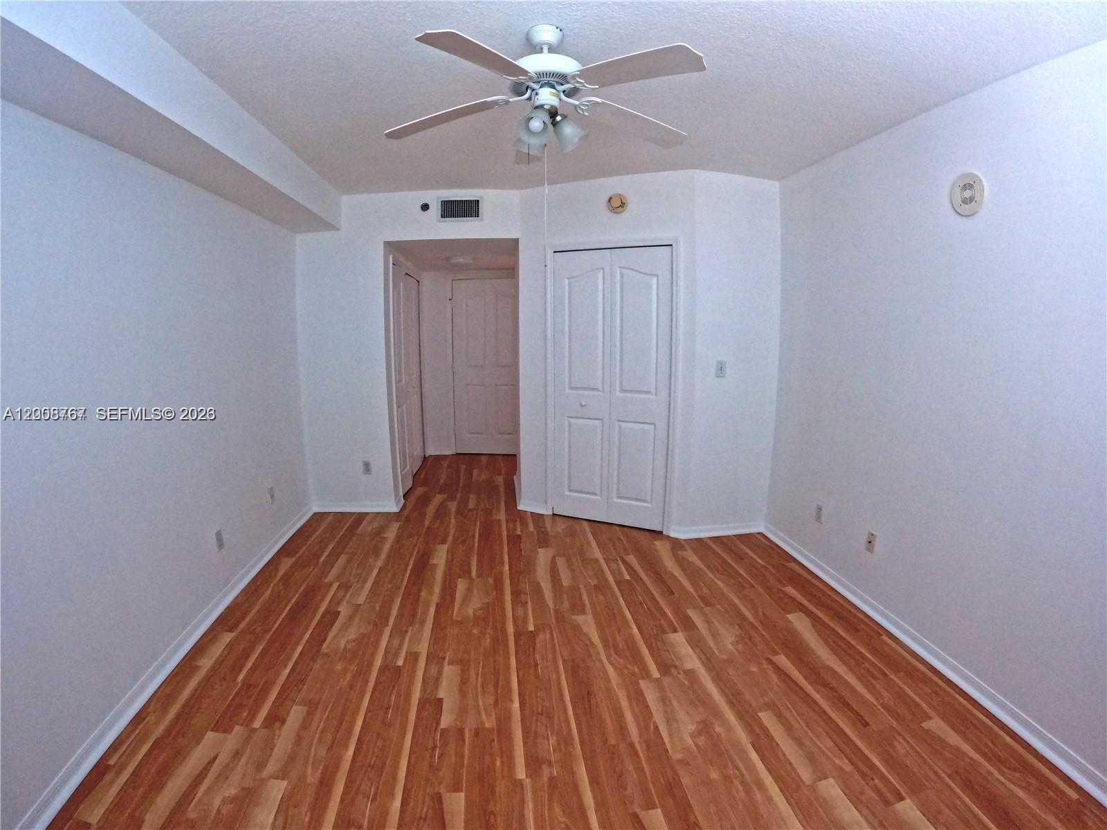 2665 Southwest 37th Avenue, Unit 710 Miami, FL 33133 - Photo 7 of 13 a view of a livingroom with wooden floor and a ceiling fan