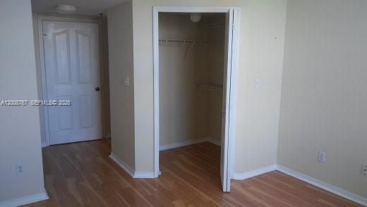 2665 Southwest 37th Avenue, Unit 710 Miami, FL 33133 - Photo 8 of 13 a view of a hallway with wooden floor