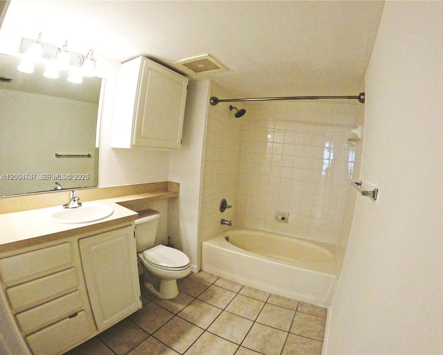 2665 Southwest 37th Avenue, Unit 710 Miami, FL 33133 - Photo 10 of 13 a bathroom with a sink a toilet and shower