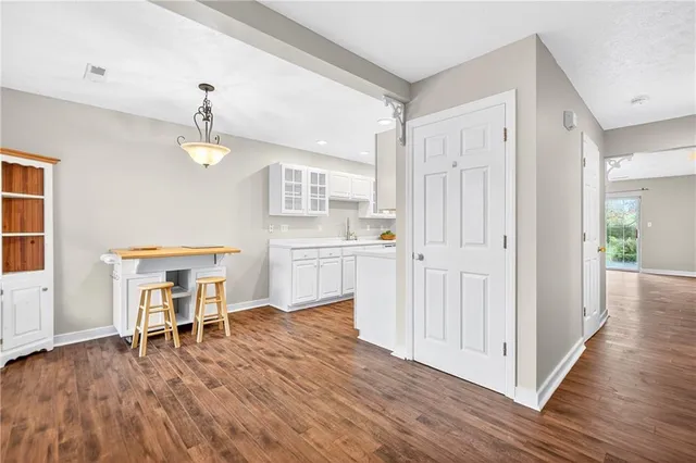 a view of a kitchen with wooden floor and chair