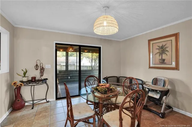 a view of a dining room with furniture and chandelier