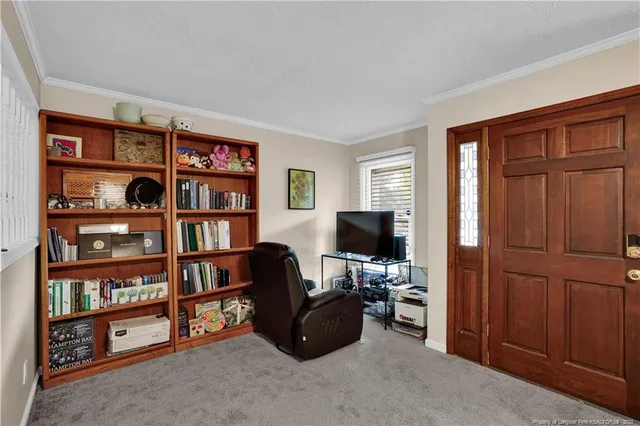 a view of a livingroom with a bookshelf and a window