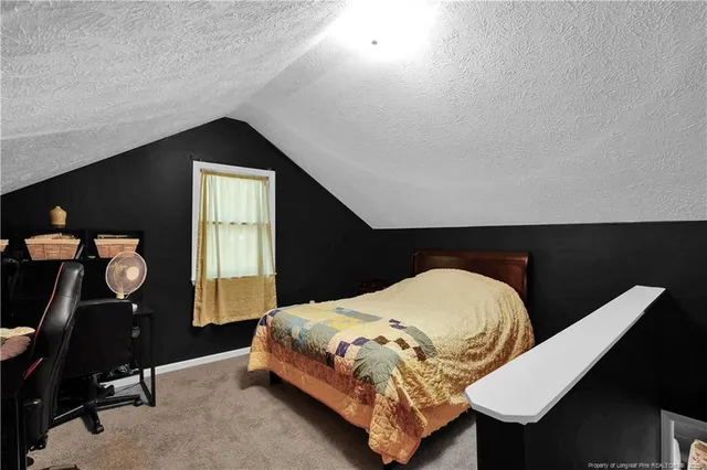 a bedroom with a bed and dresser