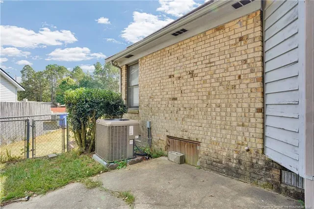 a brick building with a bench in front of it