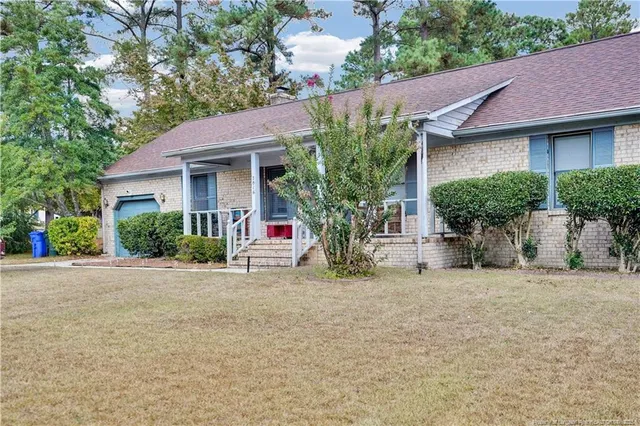 a house that has a tree in front of it