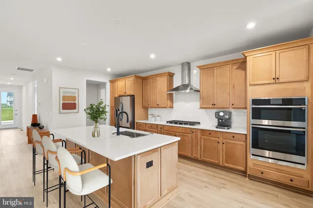 a kitchen with a stove a sink and a refrigerator