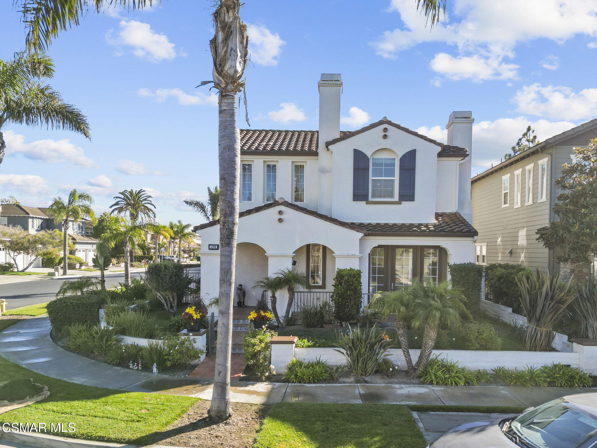 1316 Estuary Way Oxnard, CA 93035 - Photo 1 of 46 a front view of a house with a yard and lake view