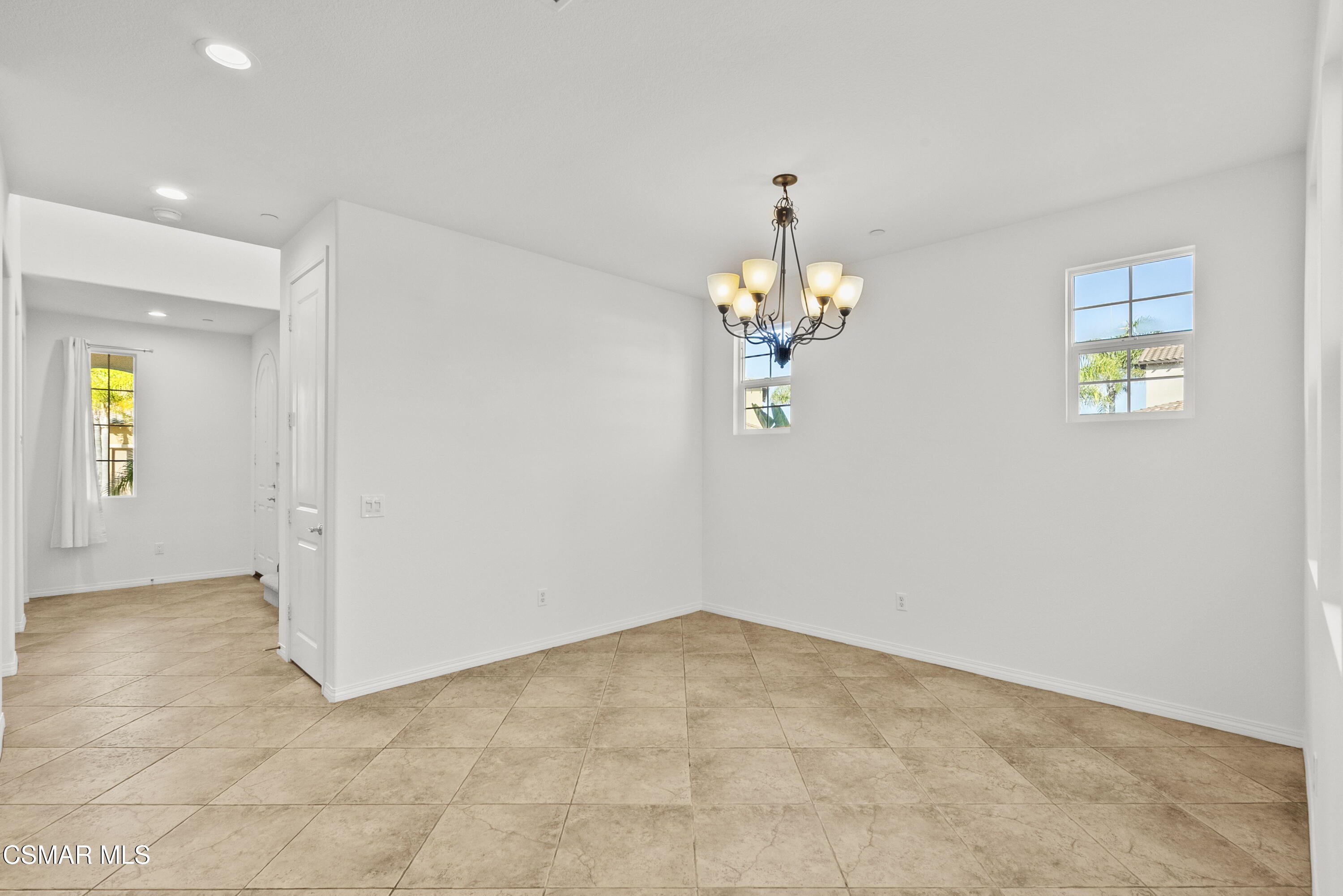 1316 Estuary Way Oxnard, CA 93035 - Photo 16 of 46 an empty room with a chandelier fan and windows
