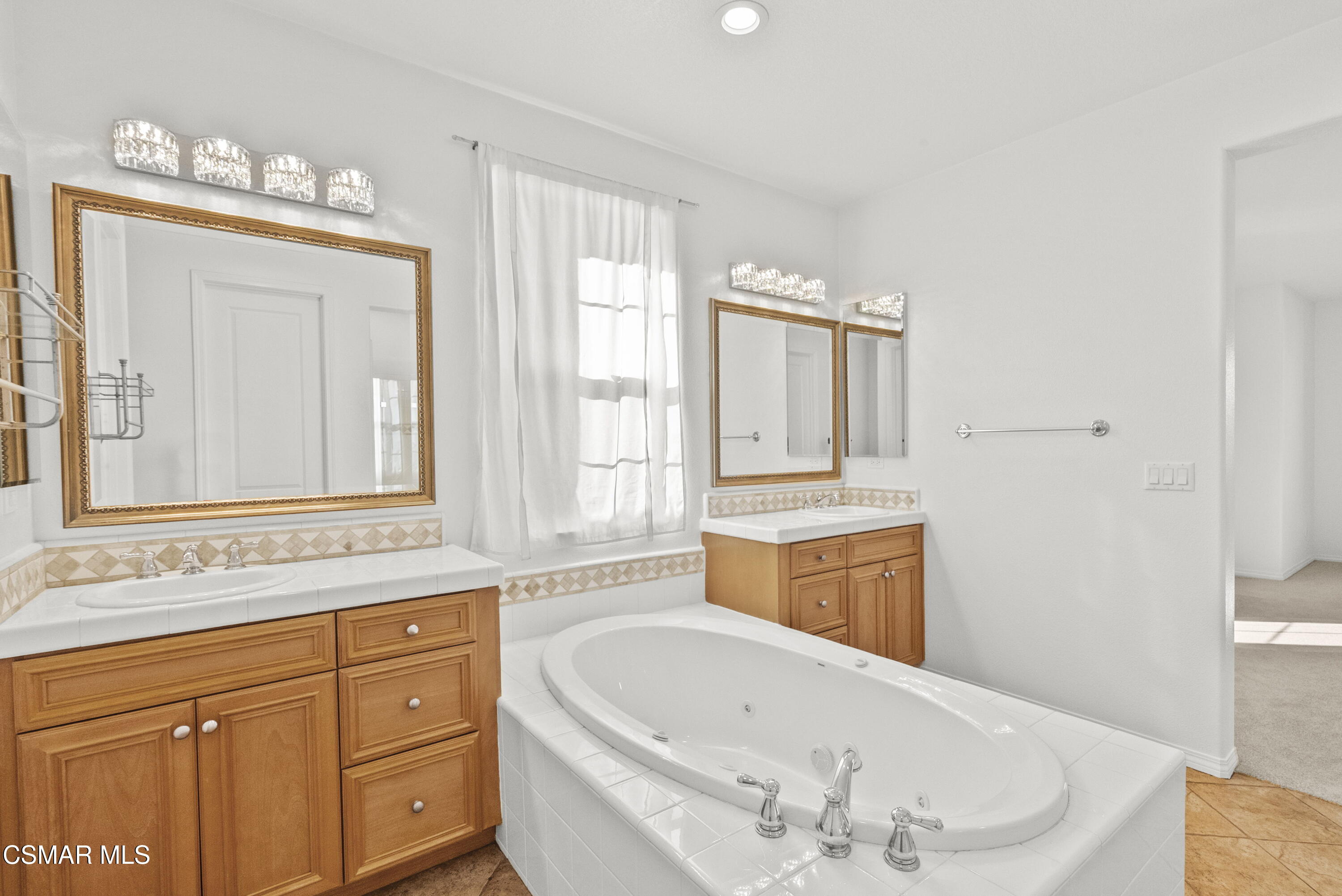 1316 Estuary Way Oxnard, CA 93035 - Photo 30 of 46 a bathroom with a bathtub sink and mirror