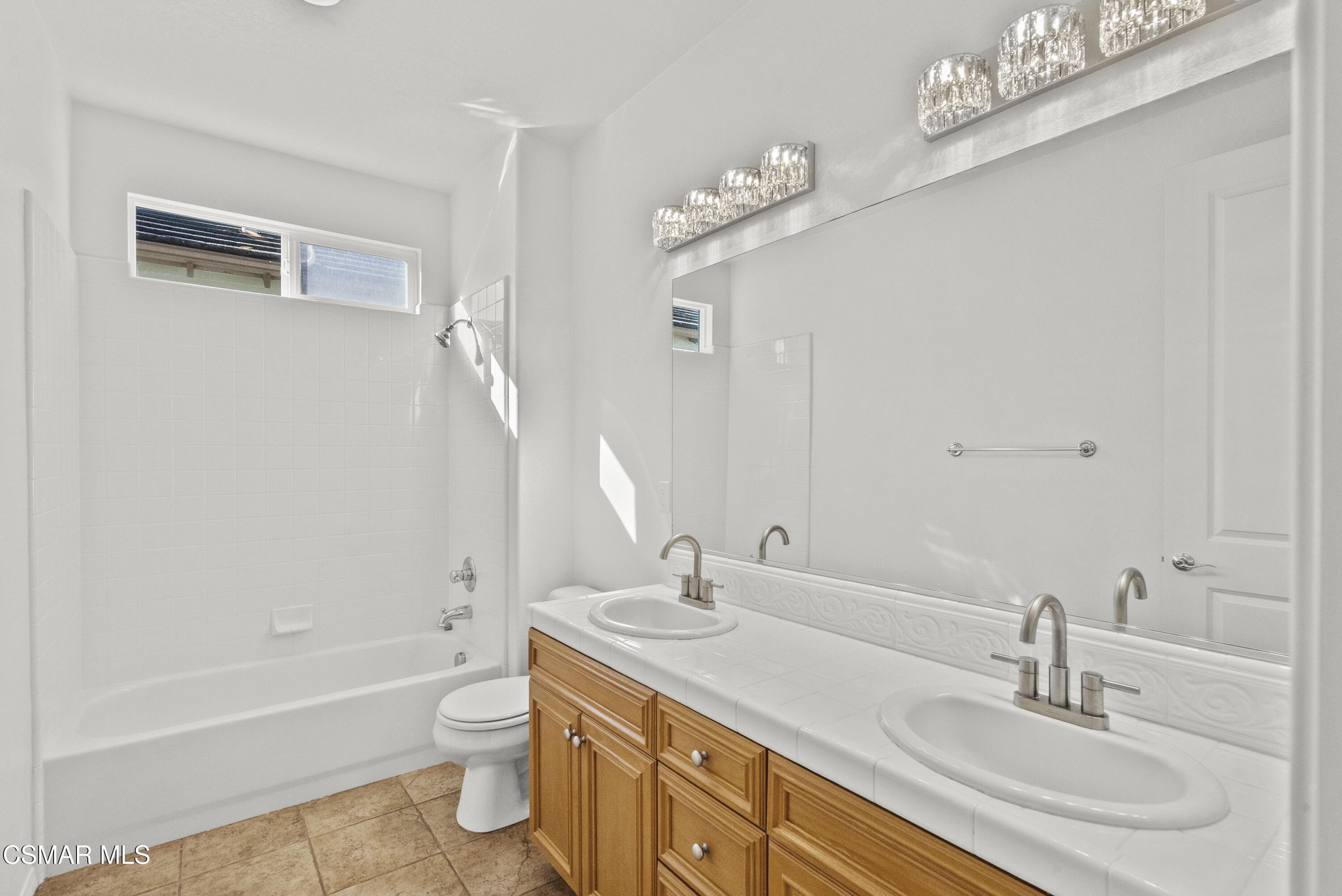 1316 Estuary Way Oxnard, CA 93035 - Photo 33 of 46 a bathroom with a double vanity sink a toilet a mirror and bathtub