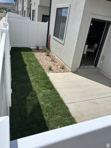 2011 West 1150 South, Unit 1042 Payson, UT 84651 - Photo 3 of 39 Photos are of model home.Private outdoor patio featuring a concrete surface, a strip of green lawn, and decorative gravel with sparse plantings