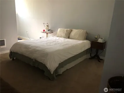 a bedroom with a bed and a chair