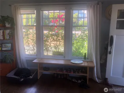 a view of a room with a window and furniture