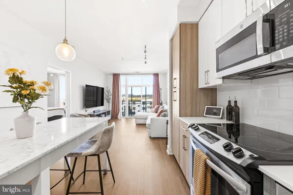 a kitchen with a stove and a wooden floors